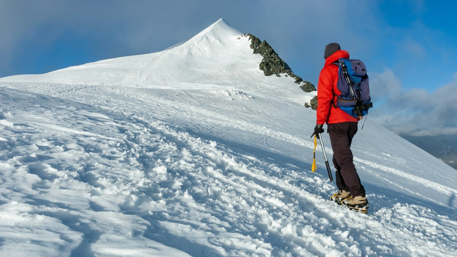 mountaineer-climbs-a-snowy-peak-in-swiss-alps-zermatt-switzerland-.jpg